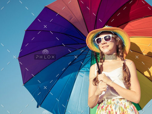 demo-attachment-35-teen-girl-with-umbrella-standing-on-the-beach-at-PMEQ6S8